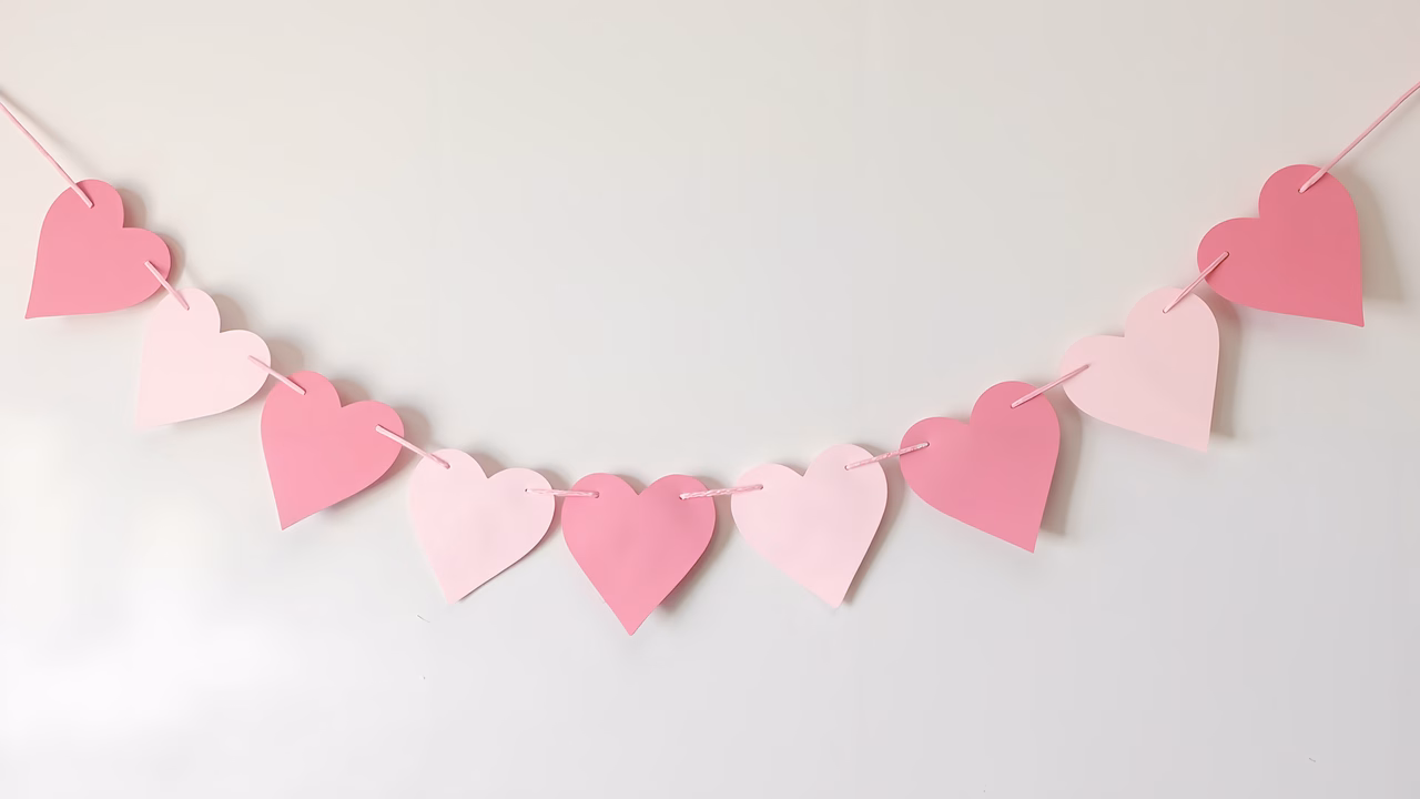 Symmetrical heart garland in soft pink tones, perfect for Valentine's Day decor.