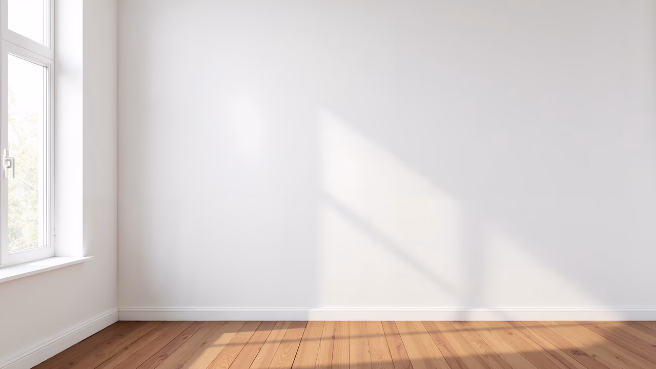 A peaceful corner with white walls and wooden floors illuminated by natural light.