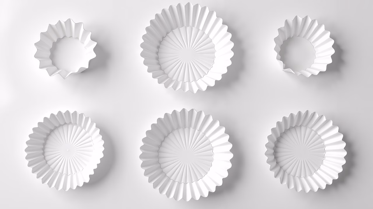 Detailed white pleated cupcake liners on a light gray background.
