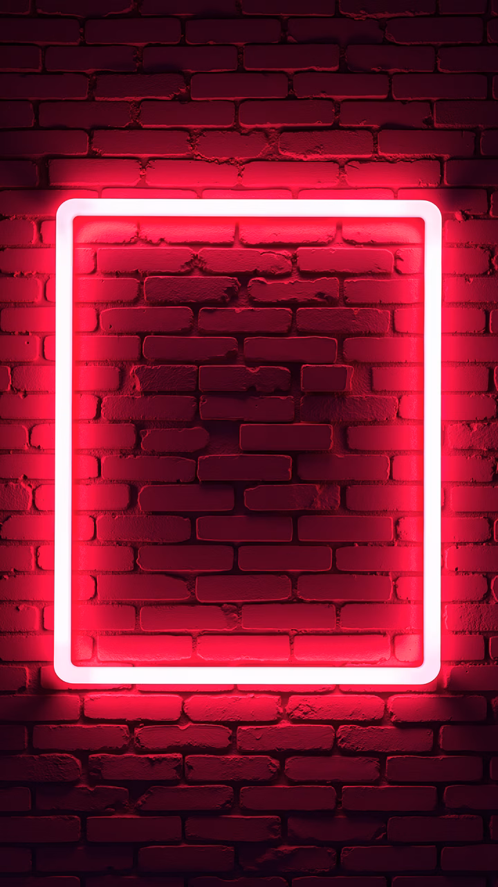 Vibrant red neon frame glowing against a textured brick wall, creating a modern urban aesthetic.