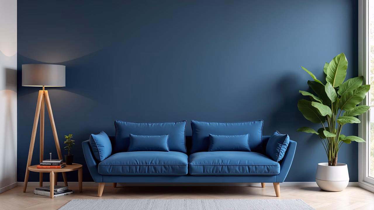 A cozy, modern living room with a blue sofa and natural light.