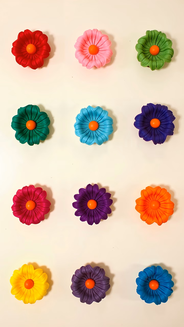 Vibrant clay flowers in a colorful grid arrangement.