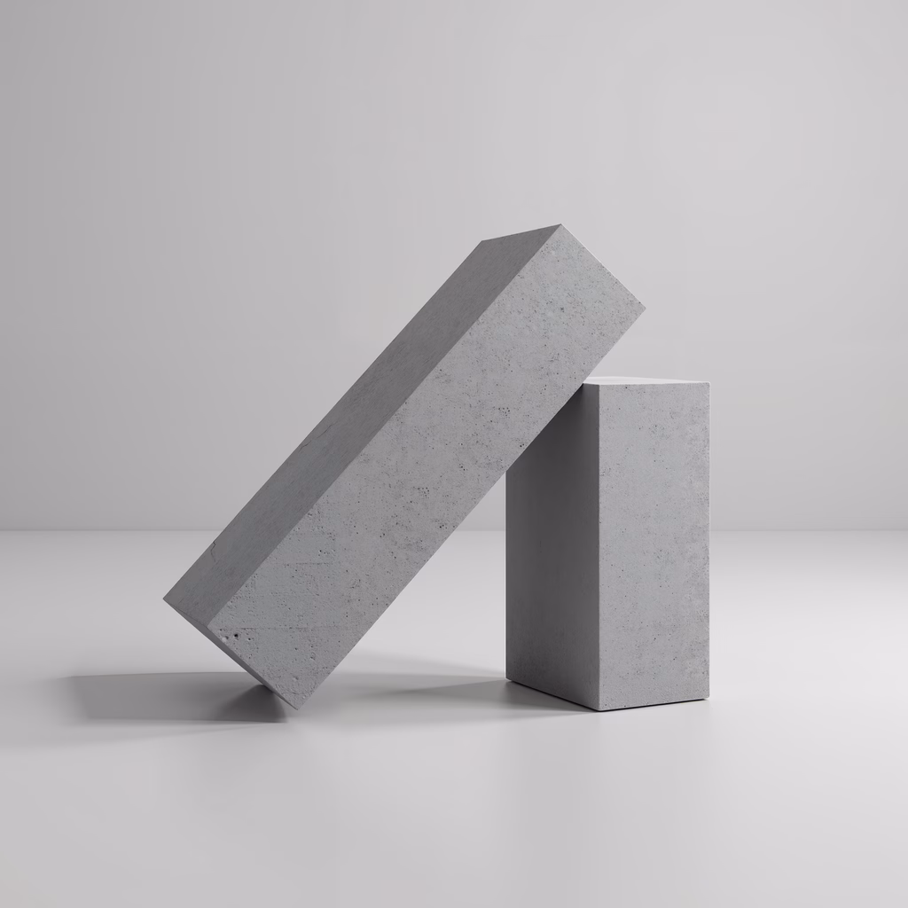 Minimalist concrete blocks balanced on each other, creating a sense of tension and stability.
