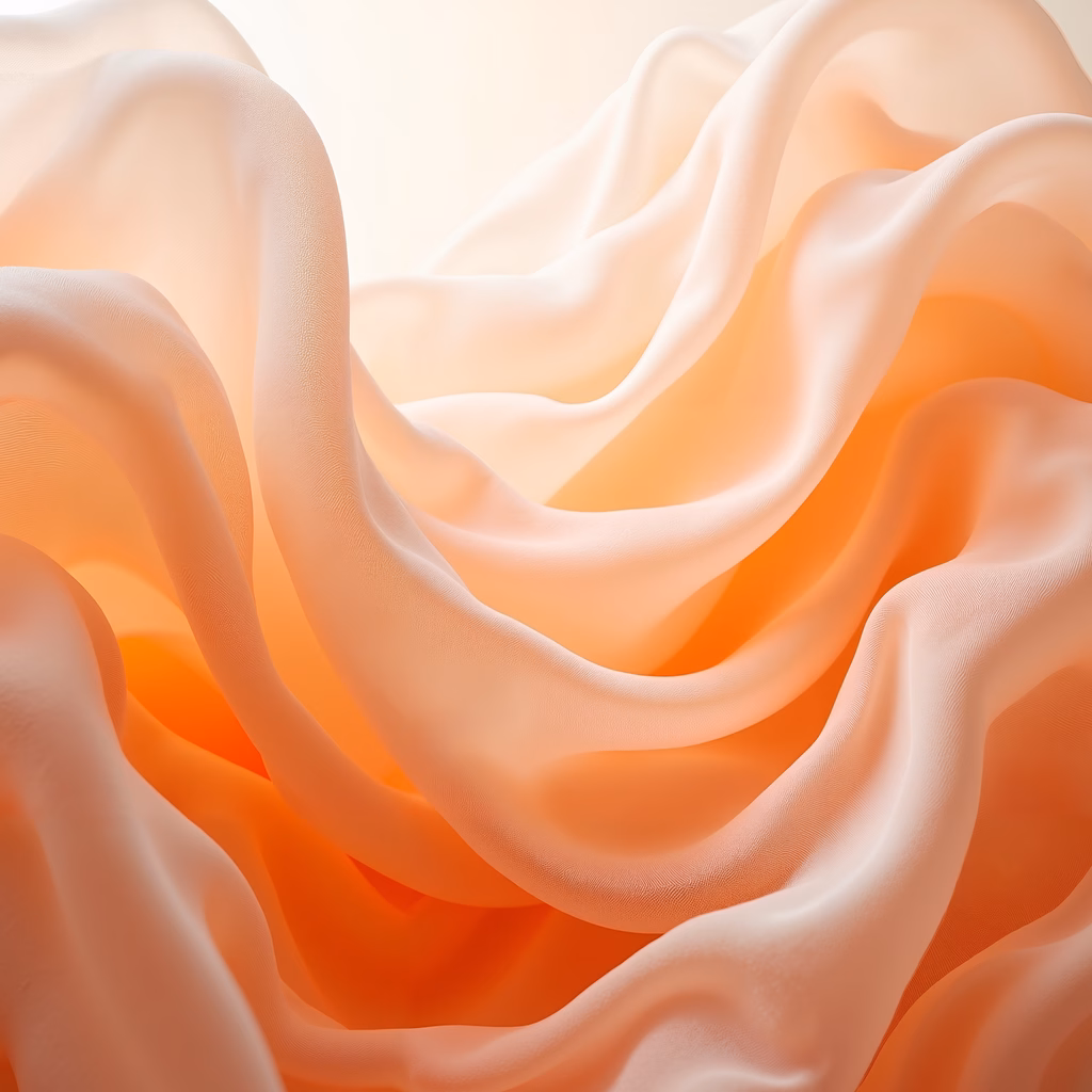 Elegant silk fabric with soft peach and orange tones, evoking tranquility and movement.