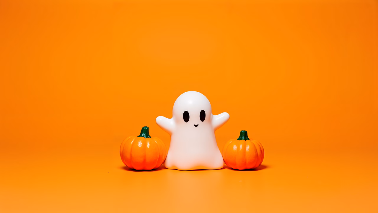 A cute ghost surrounded by pumpkins on an orange background, perfect for Halloween celebrations.