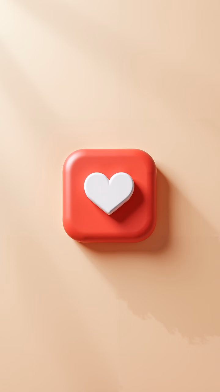 Minimalist red heart button on a beige background, conveying warmth and positivity.