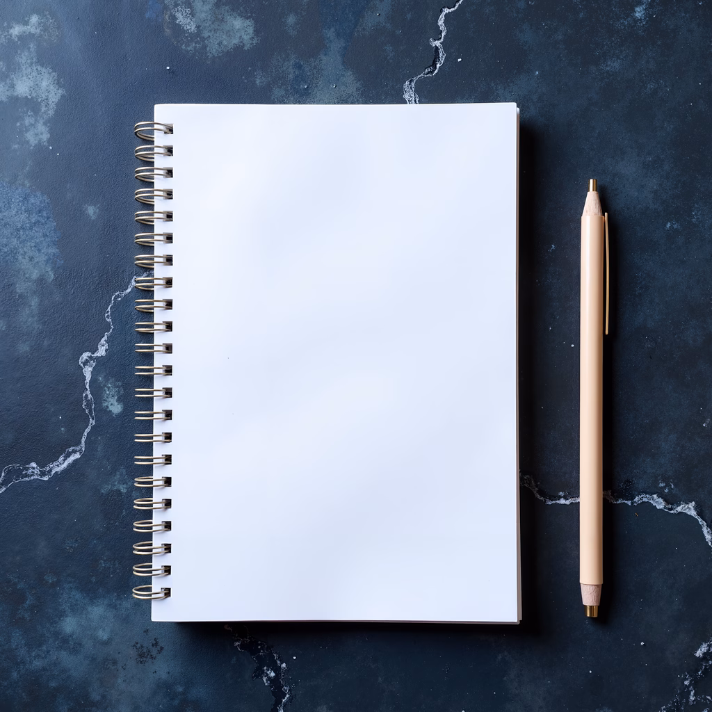 Minimalist notebook and pencil setup on a dark surface.