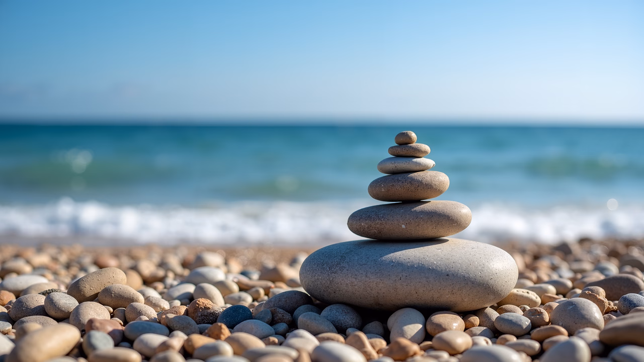 Stacked pebbles on a peaceful beach, balancing nature's simplicity.