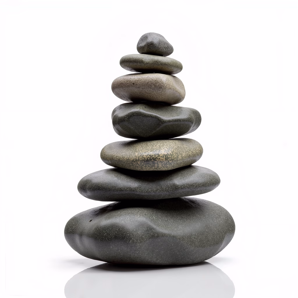 A serene stack of stones in muted greens against a white backdrop.