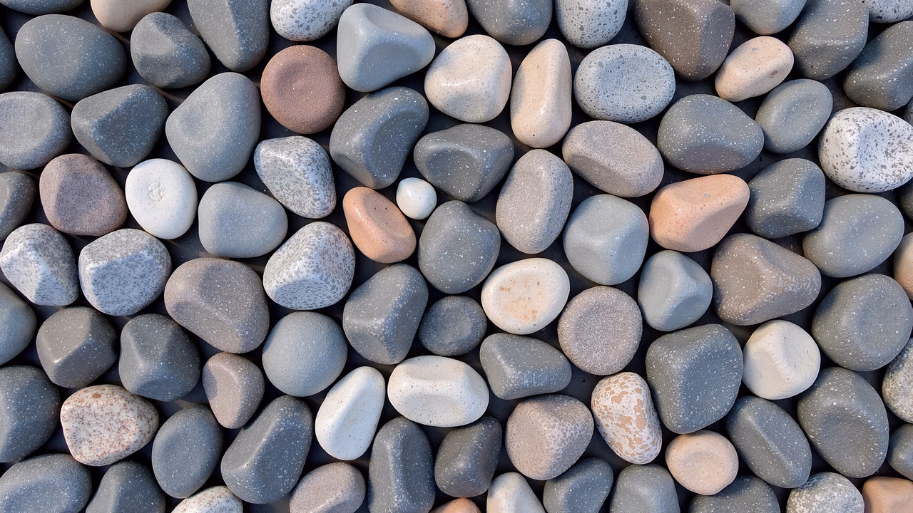 Close-up of diverse stones in shades of gray and white, creating a textured mosaic.