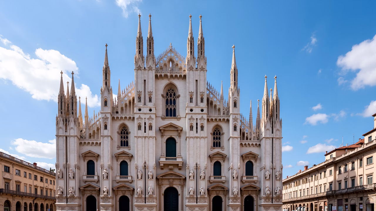 Elegant Gothic cathedral with intricate spires and warm stone tones under a clear blue sky.