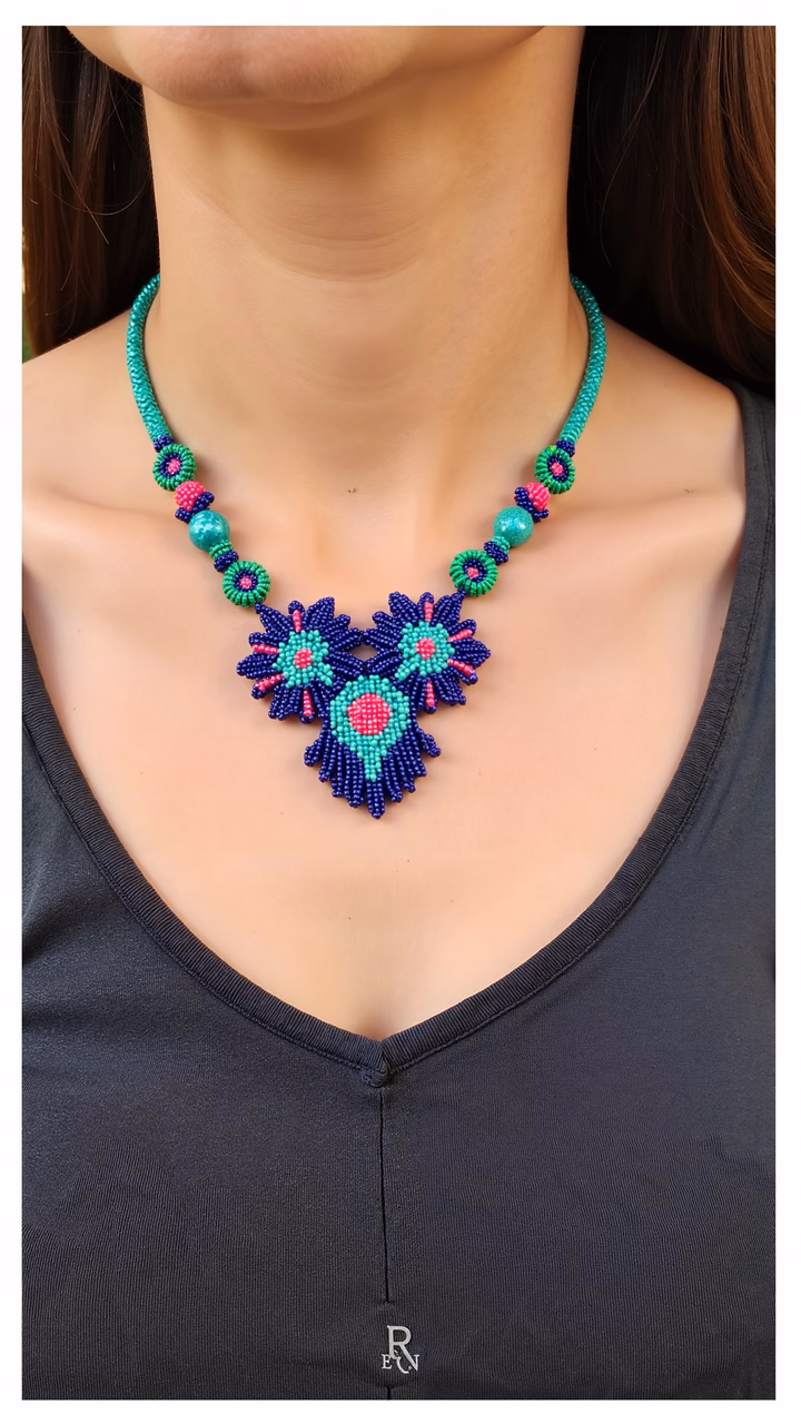Bold, colorful beaded necklace with intricate floral design on black tank top.