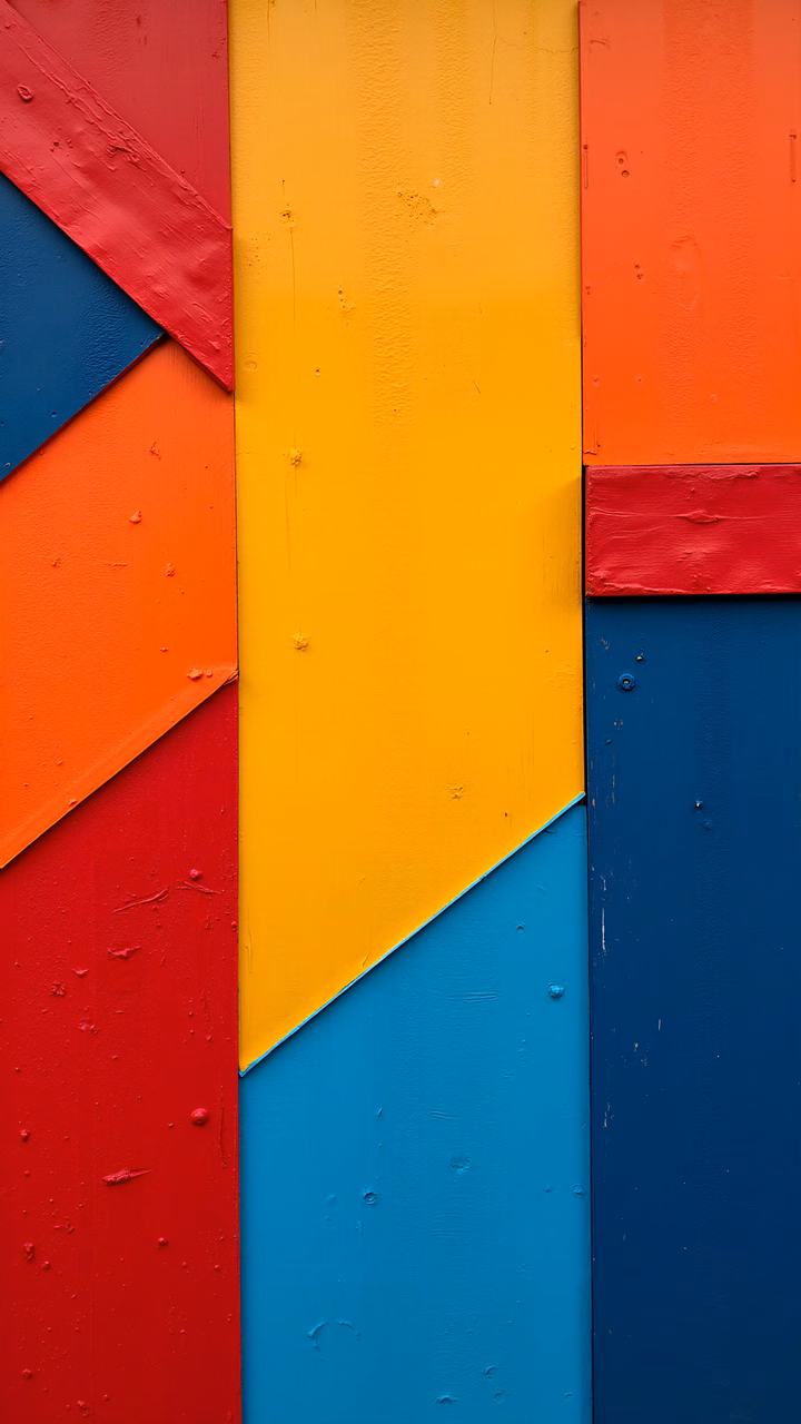 Vibrant geometric triangles in primary colors on a textured background.