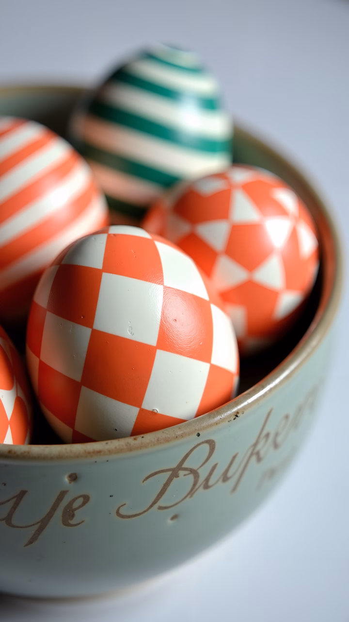Colorful Easter eggs in a pastel bowl, perfect for spring celebrations.