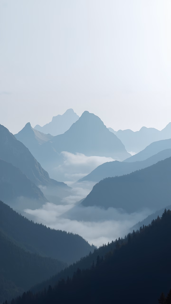 Majestic mountain range enveloped in mist, evoking tranquility and depth.