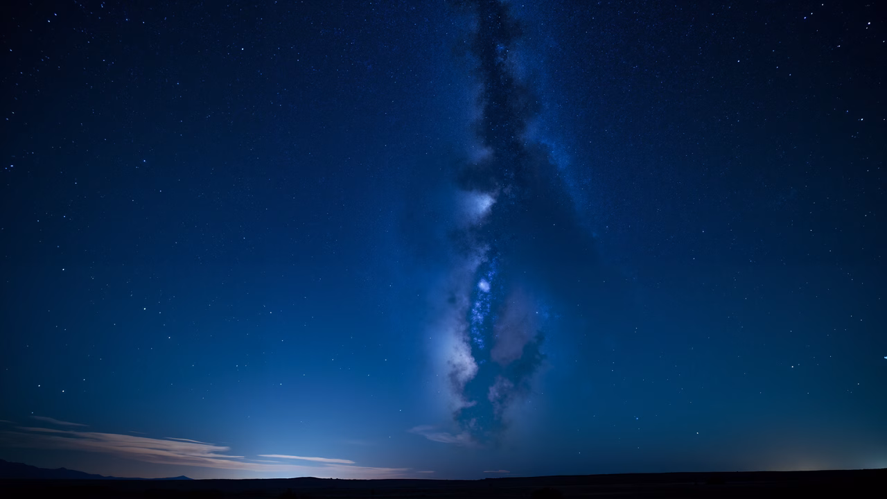 Stunning Milky Way night sky with vibrant stars and serene clouds.