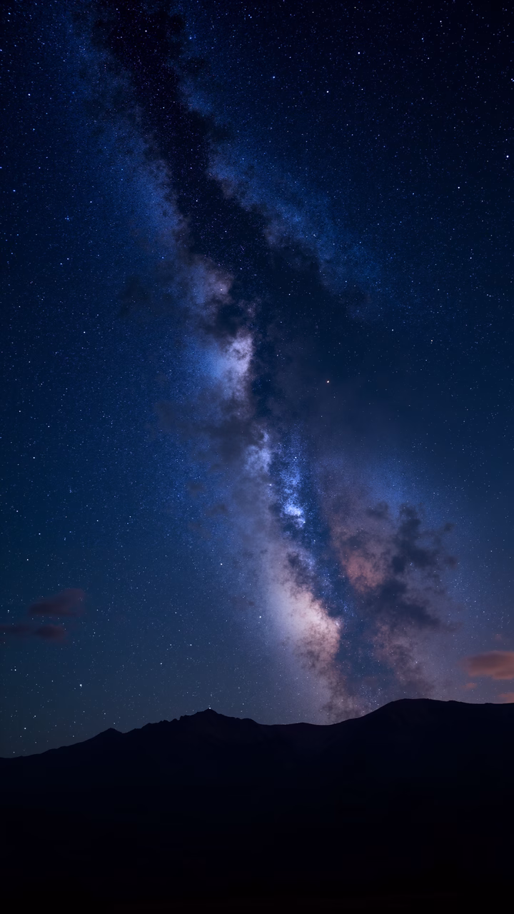 Stunning Milky Way over mountainous landscape under a starlit sky.
