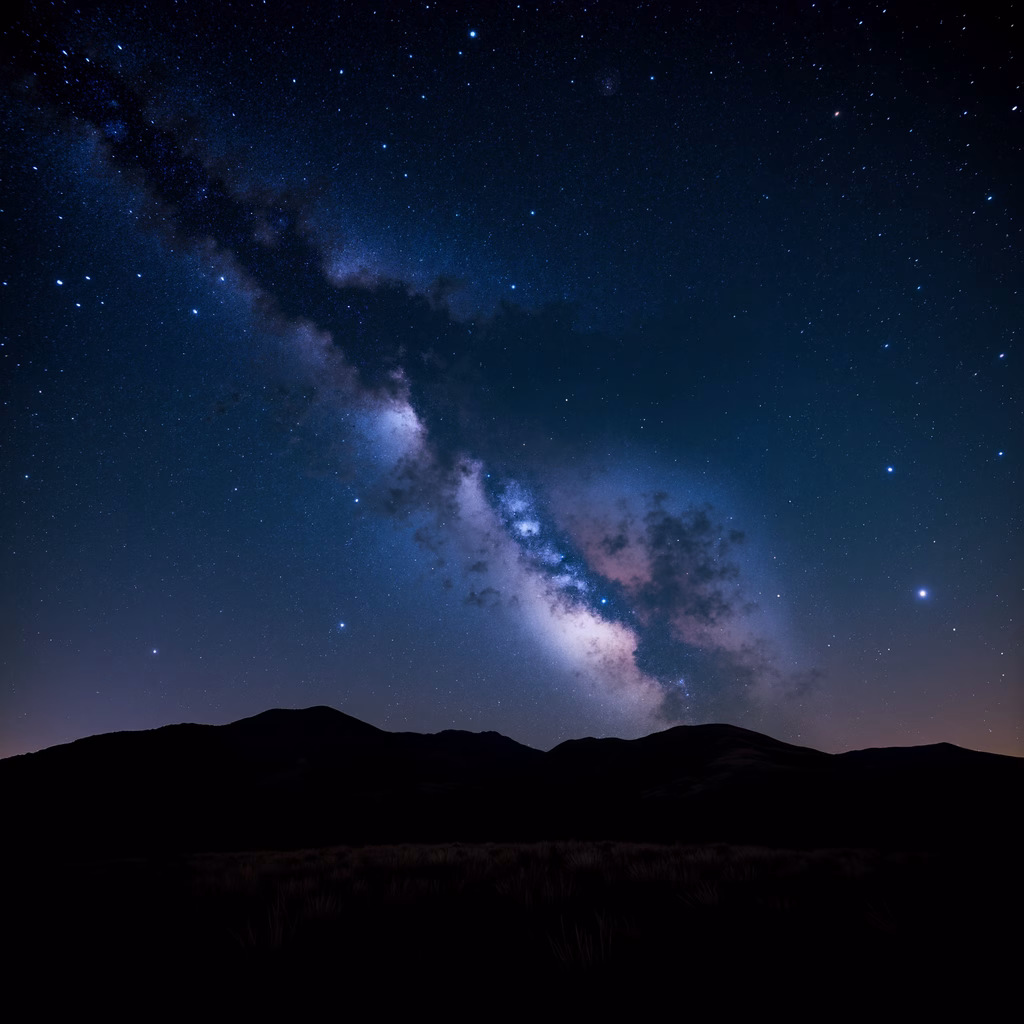 A breathtaking view of the Milky Way over silhouetted hills under a starry night sky.