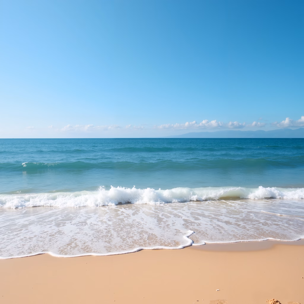 A peaceful beach scene with rolling waves and a clear blue sky.