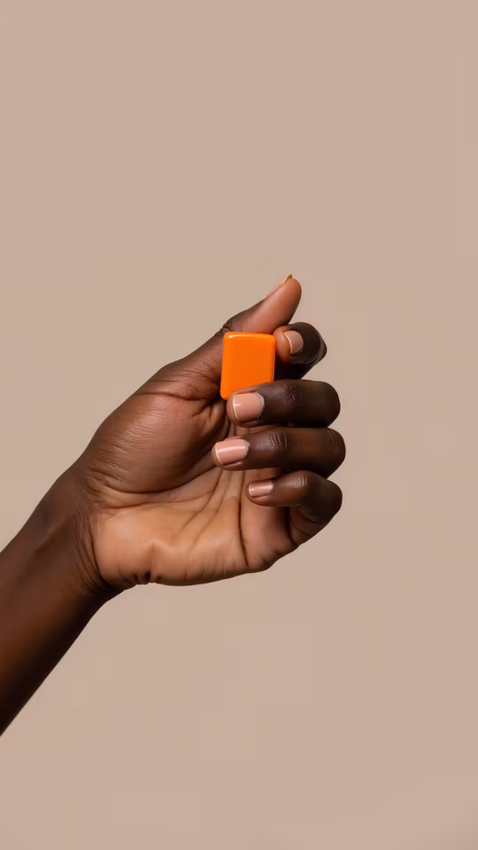 Hand Holding Orange Object