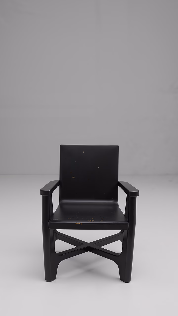 Minimalist black chair with clean lines and stark white background