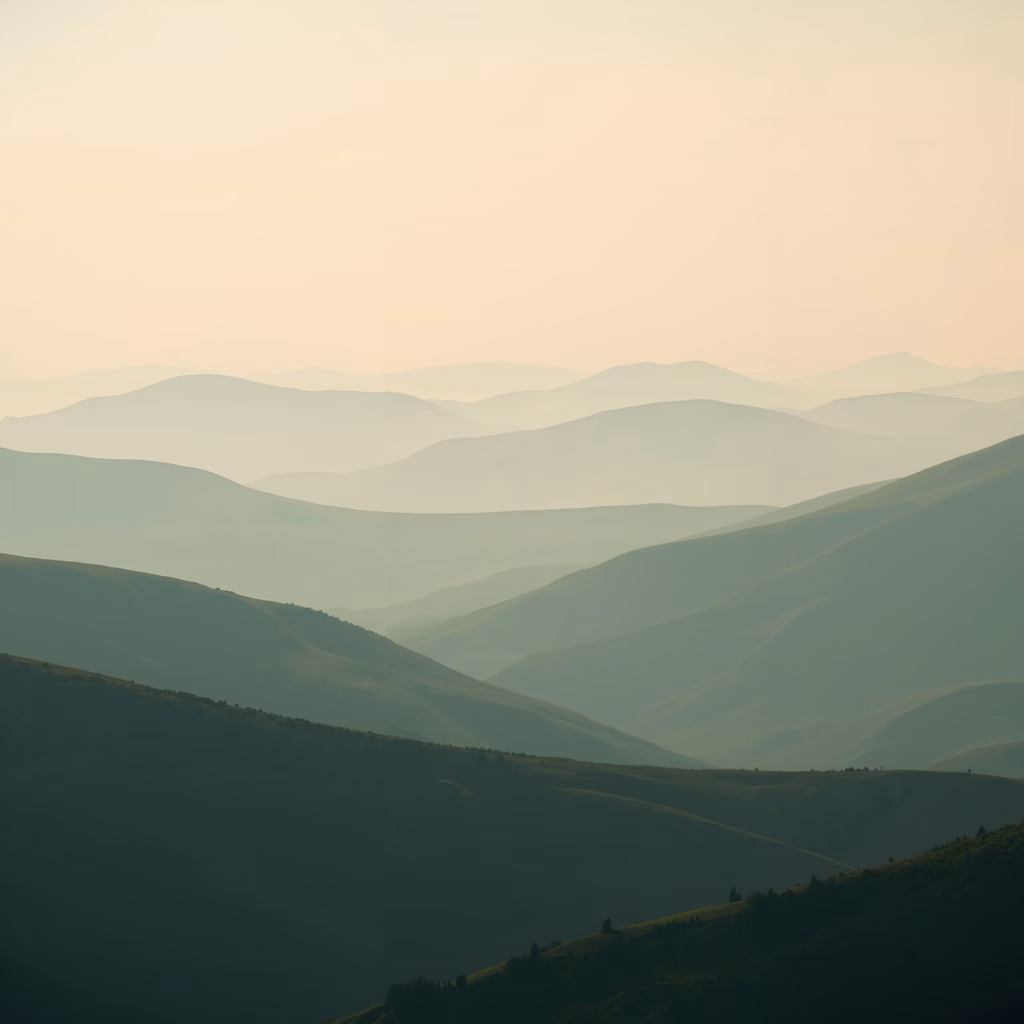 Misty hills in soft, serene landscape photography.