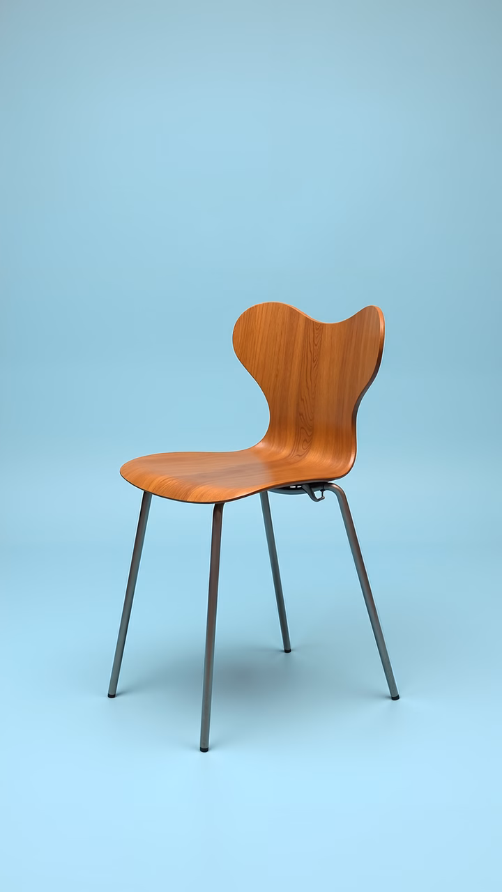 Minimalist wooden chair with metallic legs on a light blue background.