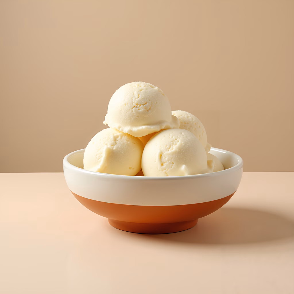 Creamy vanilla ice cream scoops in a stylish bowl on a neutral background.