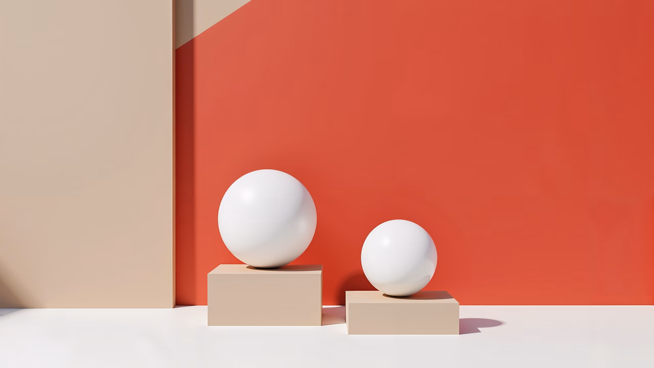 Minimalist spheres on contrasting pedestals create a striking abstract composition.