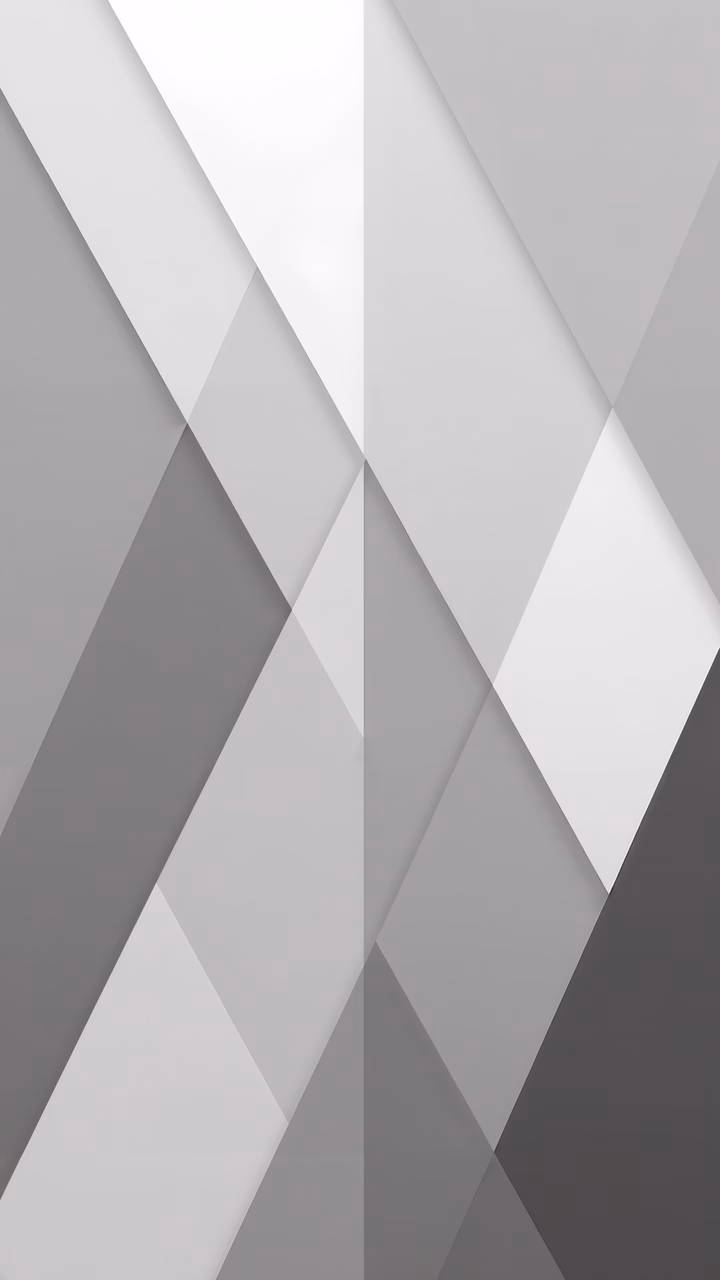 Symmetrical geometric triangles in shades of gray create a minimalist and serene design.