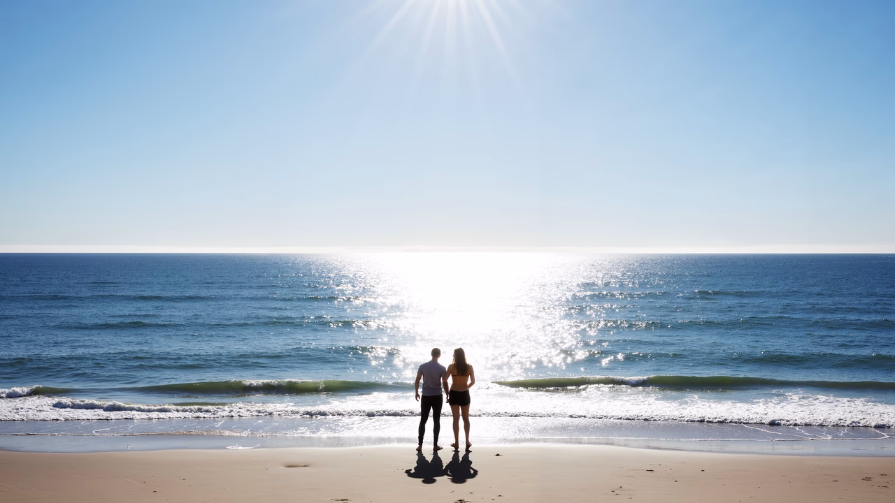 Romantic couple enjoying the beach under a sunny sky.