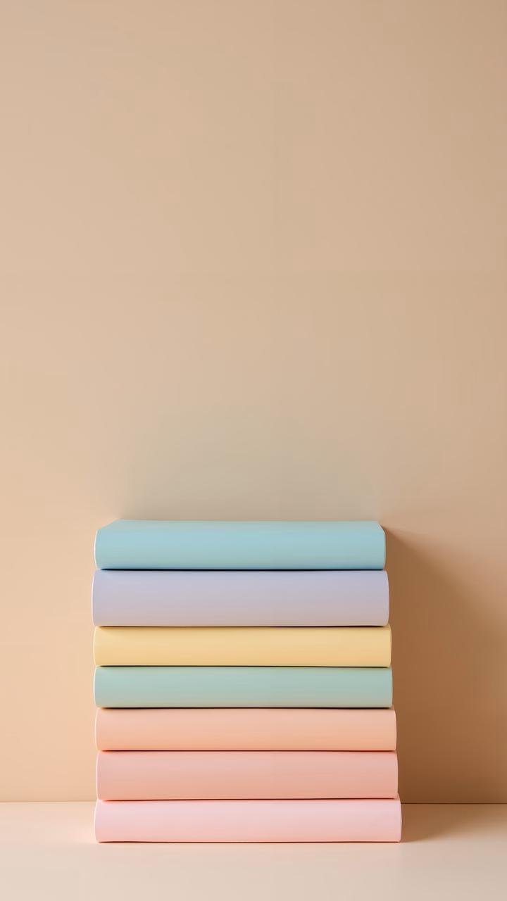 Pastel books stacked against a neutral background, minimalist design.