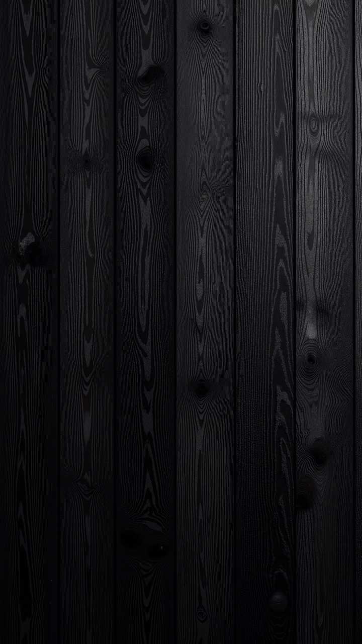 Close-up of dark wood panels with intricate grain patterns and natural knots.