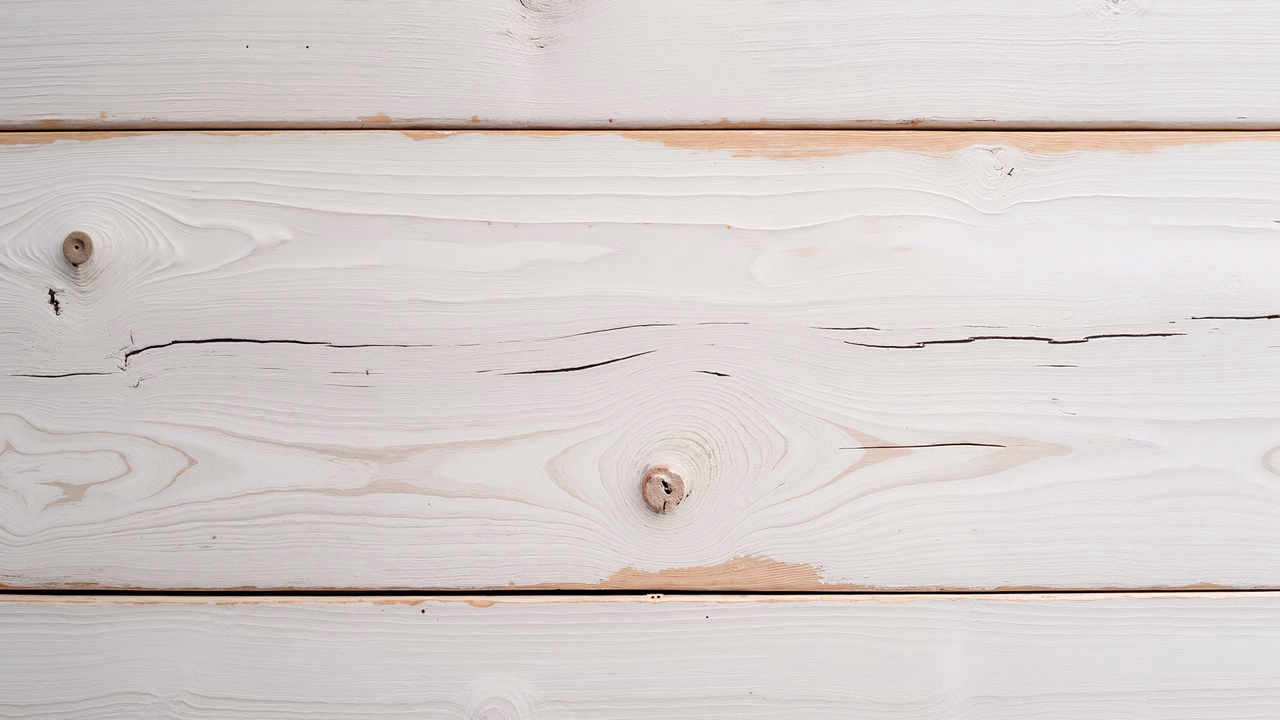 Close-up of weathered white planks, showcasing natural grain and texture.