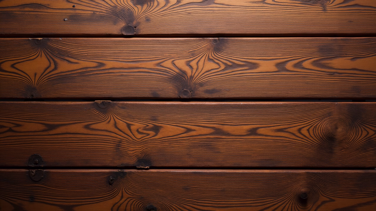 Natural wood grain patterns on horizontal planks, rich brown tones, organic texture, architectural detail.