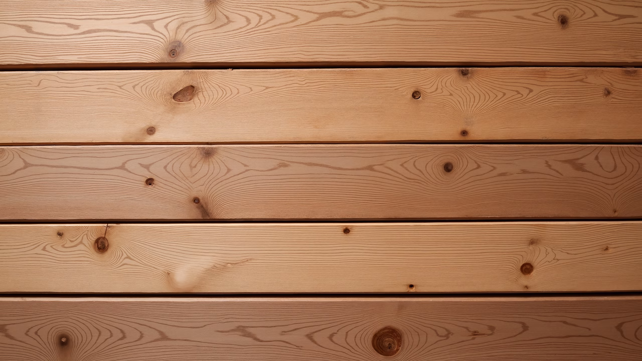 Close-up of wooden planks with natural grain and knots, showcasing rustic charm.