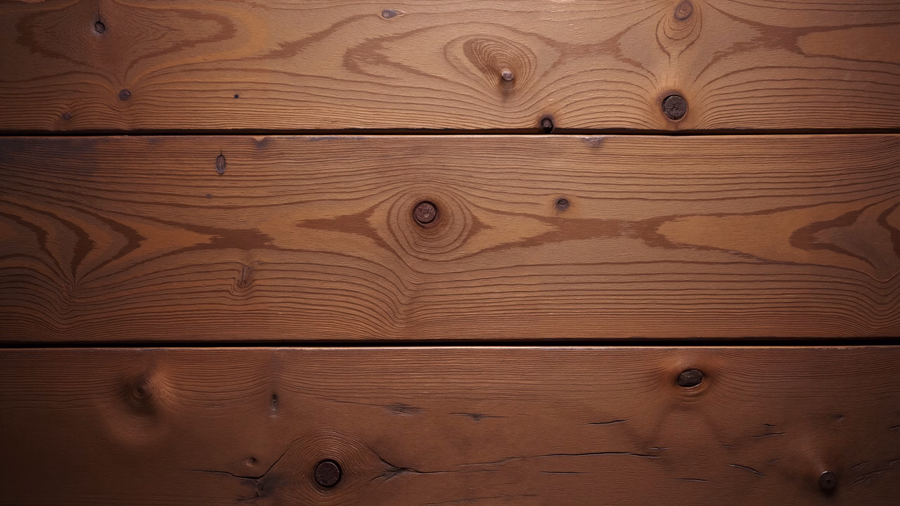 Close-up of wooden planks with natural grain patterns and knots, emphasizing rustic charm and warmth.