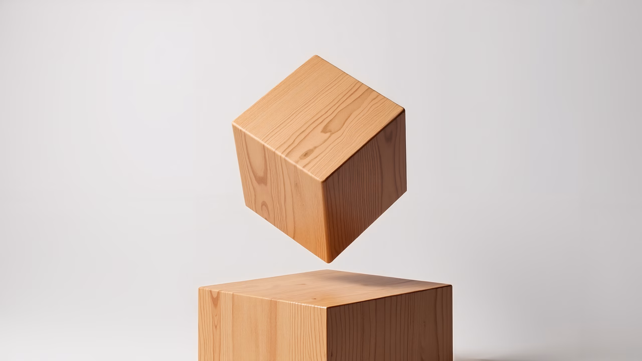 Minimalist levitating wooden cube against white backdrop