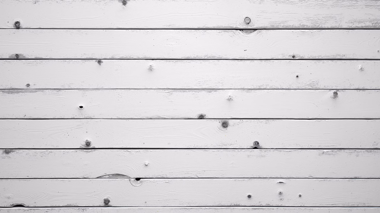 Black-and-white photo of weathered wooden planks, showcasing texture and grain patterns.