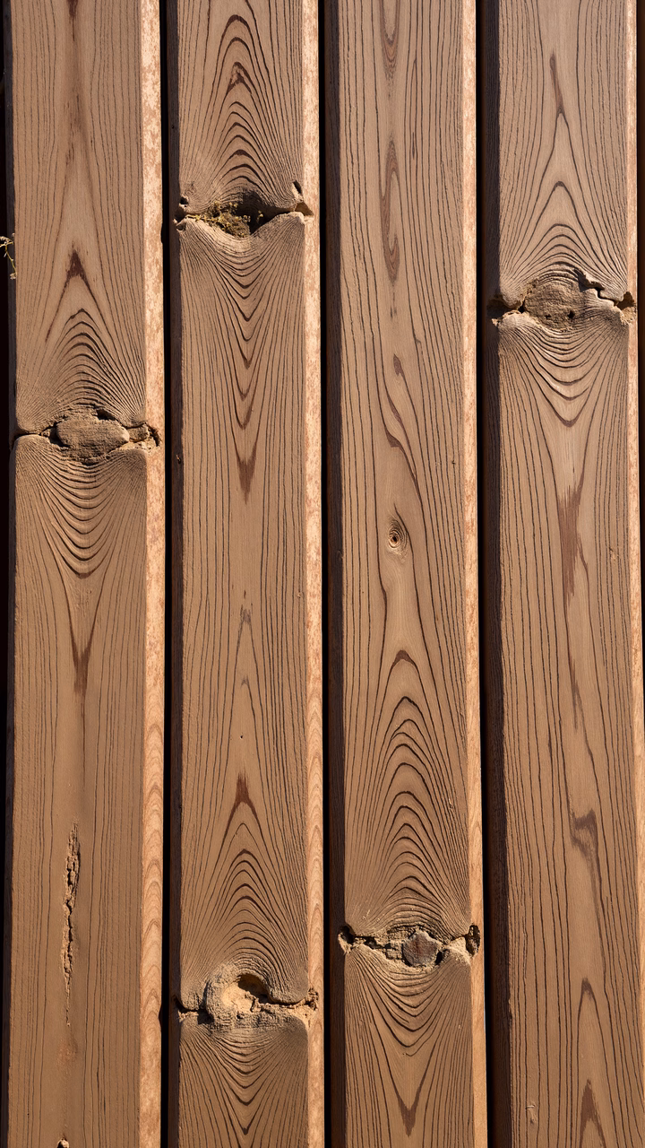 Close-up of weathered wooden planks with intricate textures and warm tones.