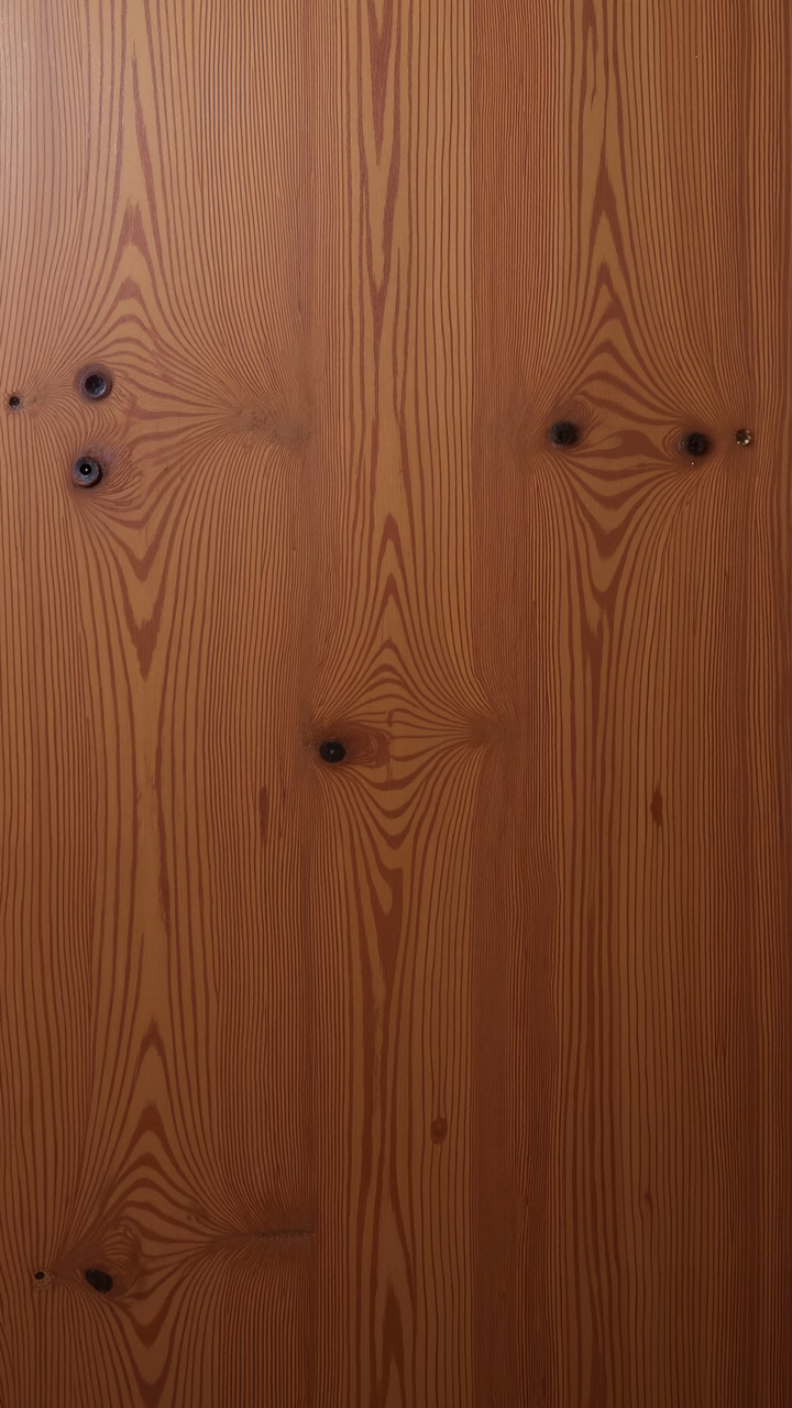 Close-up of wood grain texture with warm tones and detailed patterns.