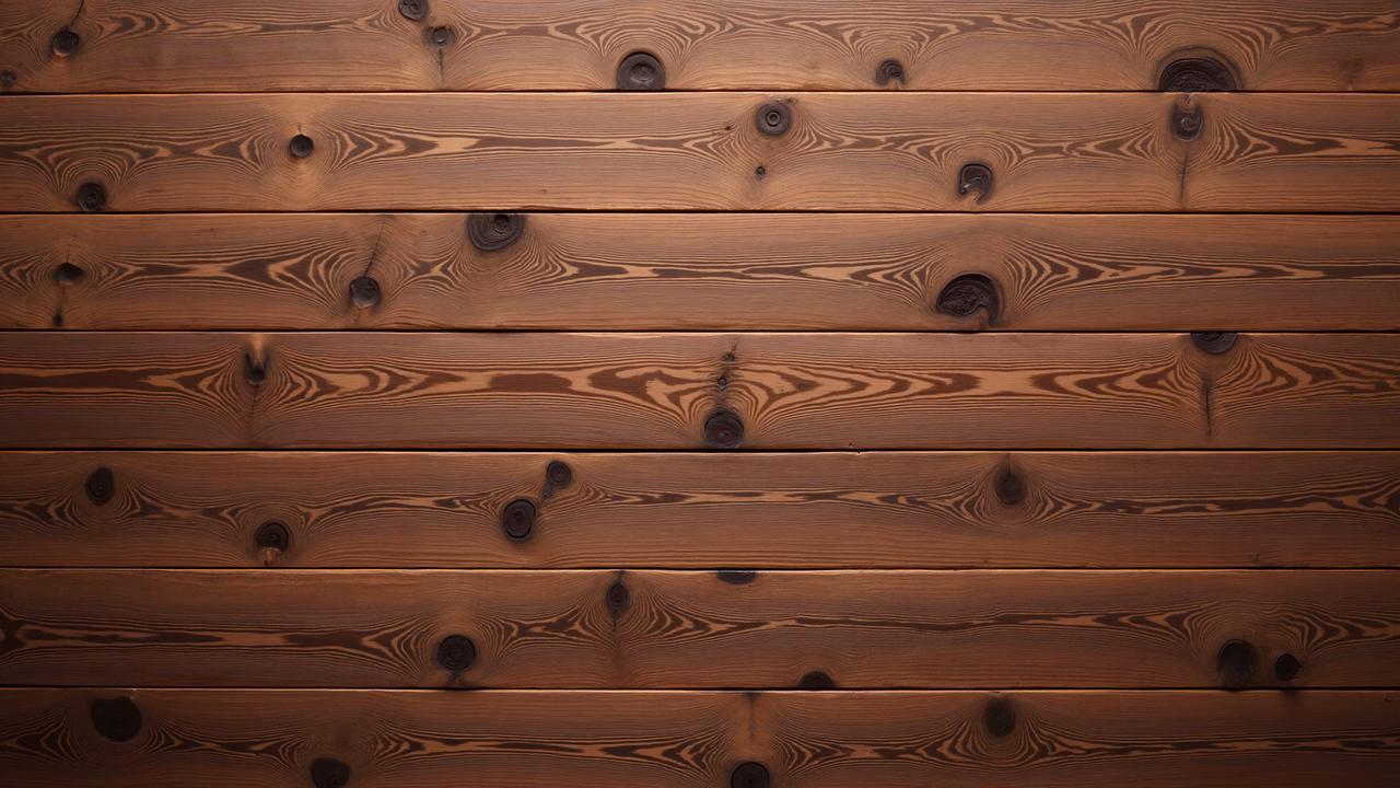 Close-up of wooden planks with natural grain patterns and knots, showcasing warm tones and rustic charm.