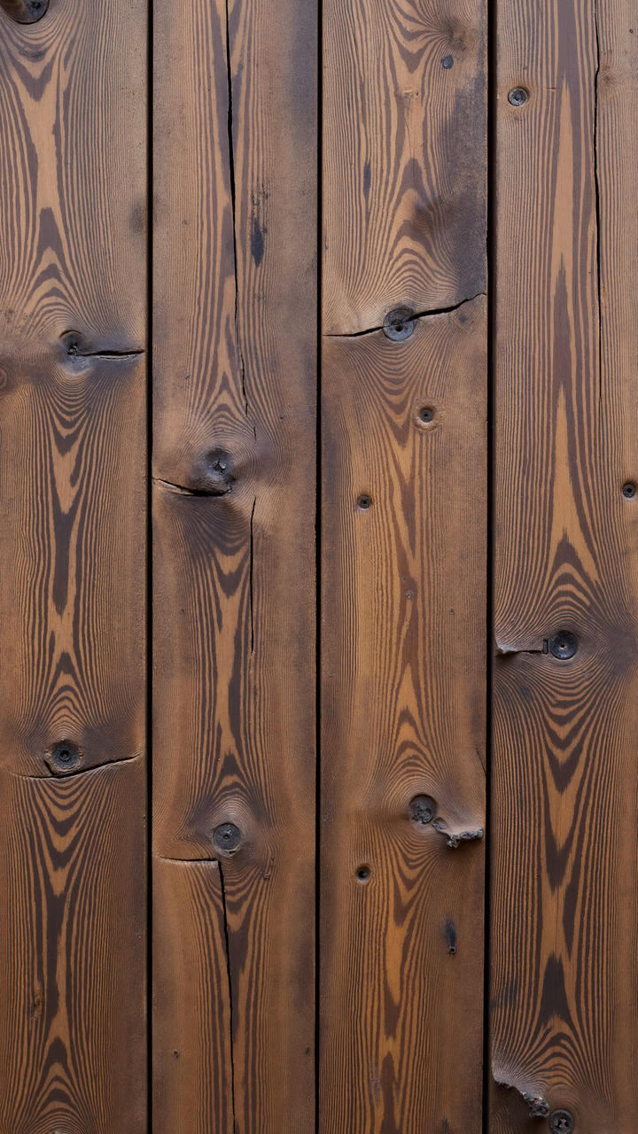 Close-up of wooden planks with detailed grain patterns and warm brown tones.