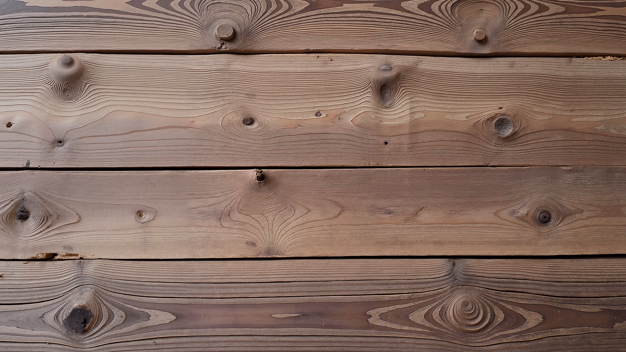 Close-up of wooden planks with natural grain and knots, evoking warmth and nostalgia.