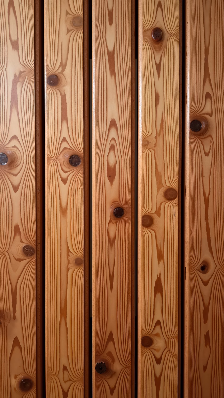 Close-up of vertical wooden planks with intricate grain patterns and warm tones.
