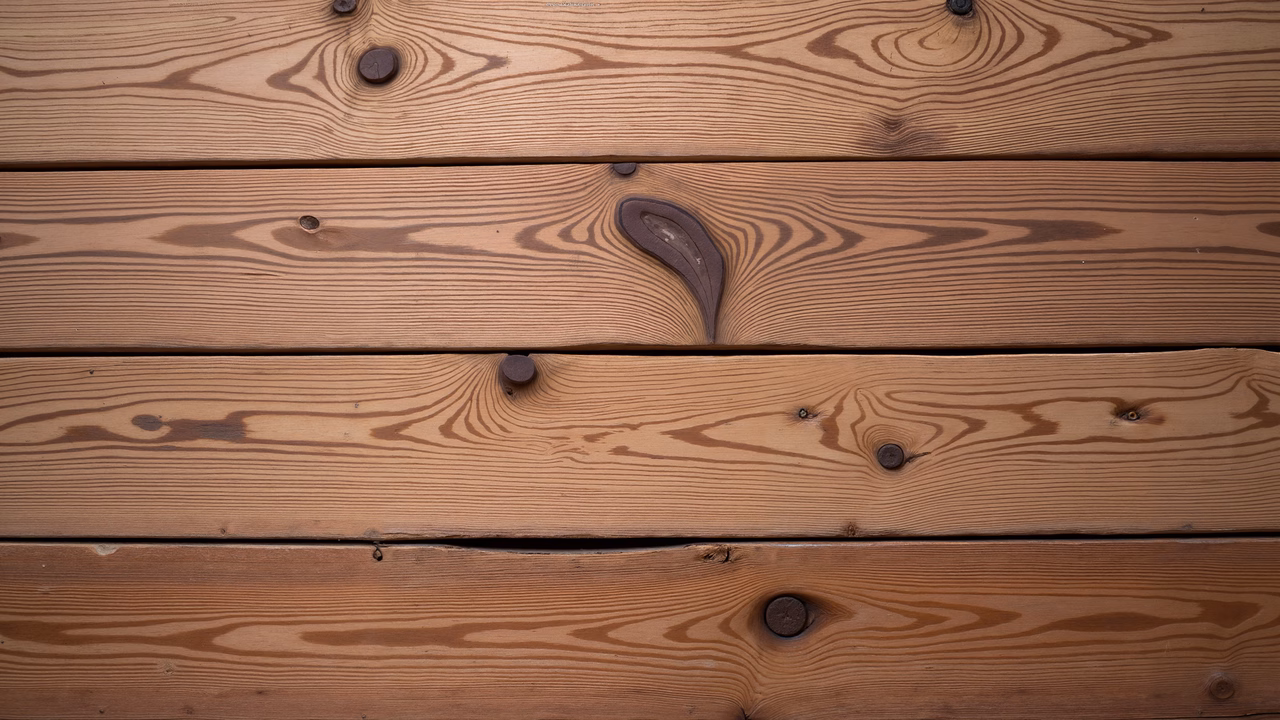 Close-up of wooden planks showcasing natural grain and knots.