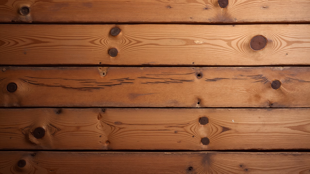 Close-up of weathered wooden planks with natural grain patterns and knots.
