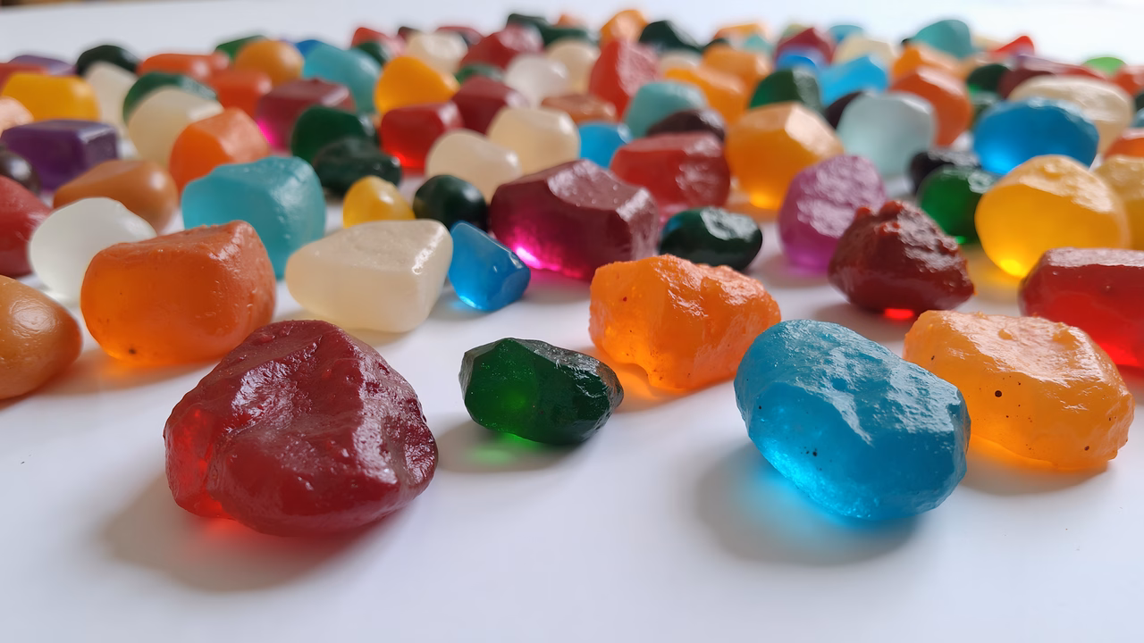 Brightly colored gummy candies on a white background, perfect for food photography enthusiasts.
