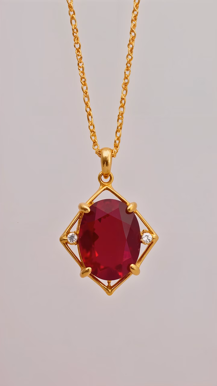 Elegant ruby pendant with gold accents and diamonds, showcasing luxury and sophistication.