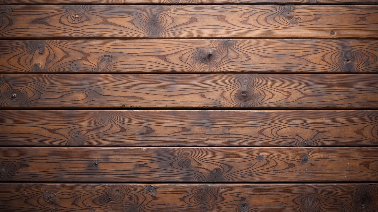 Close-up of rustic wooden planks with rich brown tones and intricate grain patterns.